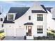 Two-story white brick home with a dark roof and a wooden front door at 5706 Closeburn Rd, Charlotte, NC 28210