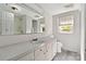 Bathroom featuring a large vanity, mirror, and a window with natural light at 6037 Pleasant Grove Rd, Charlotte, NC 28216