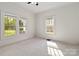 Cozy bedroom with plush carpet and natural light from three windows at 6037 Pleasant Grove Rd, Charlotte, NC 28216