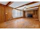 Living room featuring hardwood floors, fireplace, and wood paneling at 6037 Pleasant Grove Rd, Charlotte, NC 28216