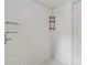 Enclosed shower with white tile and built-in shelving for toiletries and essentials at 6037 Pleasant Grove Rd, Charlotte, NC 28216