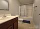 Well-lit bathroom featuring a shower-tub combo and a neutral color scheme, complemented by a wood vanity at 629 S Caldwell St, Salisbury, NC 28144