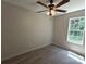 Well-lit bedroom featuring a ceiling fan, a large window, and luxury vinyl flooring, offering a modern aesthetic at 629 S Caldwell St, Salisbury, NC 28144
