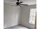 Bright bedroom features a ceiling fan, light gray walls, laminate flooring, and a window at 629 S Caldwell St, Salisbury, NC 28144