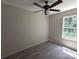 Bright bedroom featuring a ceiling fan, a large window, and luxury vinyl flooring, offering a modern aesthetic at 629 S Caldwell St, Salisbury, NC 28144