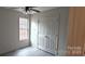 Light-filled bedroom with new gray laminate flooring, closet, and a window at 629 S Caldwell St, Salisbury, NC 28144