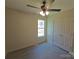 Cozy bedroom featuring a ceiling fan, a window, luxury vinyl flooring, and a closet with a double door at 629 S Caldwell St, Salisbury, NC 28144