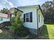 Charming home featuring a cozy front porch with black trim and an American flag at 629 S Caldwell St, Salisbury, NC 28144