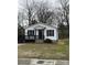 Charming home featuring a welcoming front porch, black shutters, and fresh white siding at 629 S Caldwell St, Salisbury, NC 28144