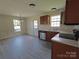 Spacious kitchen featuring wooden cabinetry, stainless steel appliances, and laminate flooring at 629 S Caldwell St, Salisbury, NC 28144