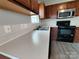 Kitchen featuring stainless steel appliances, wooden cabinetry, and a light countertop at 629 S Caldwell St, Salisbury, NC 28144
