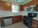 Well-equipped kitchen featuring stainless steel appliances, wooden cabinetry and new laminate flooring at 629 S Caldwell St, Salisbury, NC 28144