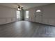 Bright living room with grey flooring, white paneled walls, and natural light at 629 S Caldwell St, Salisbury, NC 28144