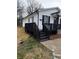 Side view of home with a black porch and access steps on a manicured lawn at 629 S Caldwell St, Salisbury, NC 28144