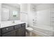 Clean bathroom with tub shower, vanity, and toilet at 7011 Jane Parks Way, Charlotte, NC 28217