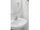Modern bathroom with a pedestal sink and oval mirror at 7011 Jane Parks Way, Charlotte, NC 28217