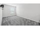 Spacious bedroom with gray carpet and window at 7011 Jane Parks Way, Charlotte, NC 28217
