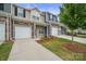 Exterior of townhome with front door, garage, and landscaping at 7011 Jane Parks Way, Charlotte, NC 28217