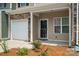 Front entry of townhome with door and garage at 7011 Jane Parks Way, Charlotte, NC 28217