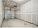 Unfinished garage with overhead door and ample space at 7011 Jane Parks Way, Charlotte, NC 28217
