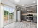 Modern kitchen with gray cabinets, granite counters, and stainless steel appliances at 7011 Jane Parks Way, Charlotte, NC 28217