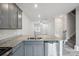 Modern kitchen with gray cabinets, granite counters, and stainless steel appliances at 7011 Jane Parks Way, Charlotte, NC 28217