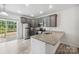 Modern kitchen with gray cabinets, granite counters, and stainless steel appliances at 7011 Jane Parks Way, Charlotte, NC 28217