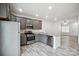 Modern kitchen with gray cabinets, granite counters, and stainless steel appliances at 7011 Jane Parks Way, Charlotte, NC 28217