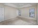 Carpeted bedroom with ceiling fan and ample natural light at 7117 Flying Scotsman Dr, Charlotte, NC 28213