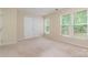 Bedroom with carpet, double windows with blinds, and double-door closet at 7117 Flying Scotsman Dr, Charlotte, NC 28213