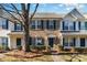 Brick townhome with 2-story facade, green trim, and landscaping at 7117 Flying Scotsman Dr, Charlotte, NC 28213