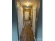 Long hallway with multiple closet doors, hardwood floors, and lighting to enhance the space at 7117 Flying Scotsman Dr, Charlotte, NC 28213