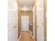 Hallway with natural light, neutral walls, and white paneled doors, offering a warm and inviting atmosphere at 7117 Flying Scotsman Dr, Charlotte, NC 28213