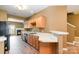 Charming kitchen with wood cabinets, white countertops, modern appliances, and an open view to the living area at 7117 Flying Scotsman Dr, Charlotte, NC 28213