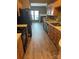 Traditional eat-in kitchen with wood cabinets, black appliances, and hardwood floors, perfect for cooking and dining at 7117 Flying Scotsman Dr, Charlotte, NC 28213