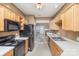Galley kitchen with light wood cabinets, black appliances, and white countertops at 7117 Flying Scotsman Dr, Charlotte, NC 28213