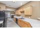 Galley kitchen with light wood cabinets, black appliances, and white countertops at 7117 Flying Scotsman Dr, Charlotte, NC 28213