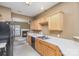 Galley kitchen with light wood cabinets, black appliances, and white countertops at 7117 Flying Scotsman Dr, Charlotte, NC 28213