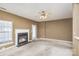 Living room with carpet, fireplace, ceiling fan and view of kitchen at 7117 Flying Scotsman Dr, Charlotte, NC 28213