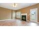 Spacious living room featuring a fireplace, ceiling fan, laminate flooring, and a glass door leading to the backyard at 7117 Flying Scotsman Dr, Charlotte, NC 28213