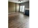 Spacious living room with a cozy fireplace, ceiling fan, and abundant natural light at 7117 Flying Scotsman Dr, Charlotte, NC 28213
