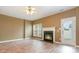 Bright living room featuring fireplace, ceiling fan, wood-look floors, and natural light from windows and the door at 7117 Flying Scotsman Dr, Charlotte, NC 28213