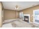 Living room with carpet, fireplace, ceiling fan, and access to patio at 7117 Flying Scotsman Dr, Charlotte, NC 28213