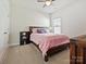 Cozy bedroom featuring a wood-frame bed and a window providing natural light at 7522 Porrera St, Charlotte, NC 28214