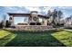 Stone community entrance with decorative pergola, landscaping, and visible neighborhood signage at 7522 Porrera St, Charlotte, NC 28214