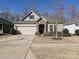 Charming home featuring stone accents, a two-car garage, and a well-manicured front yard at 7522 Porrera St, Charlotte, NC 28214