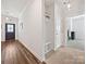 Hallway with a coat rack and bench that transitions between tile and wood-look flooring at 7522 Porrera St, Charlotte, NC 28214