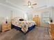 Serene main bedroom features a tray ceiling, ceiling fan, and neutral color scheme at 7522 Porrera St, Charlotte, NC 28214