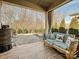 Relaxing outdoor patio with comfortable seating, covered space, and view of the backyard at 7522 Porrera St, Charlotte, NC 28214