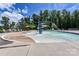 Gathering-friendly pool area with a zero entry splash pad, water features, and lounge chairs for relaxation under the sun at 7522 Porrera St, Charlotte, NC 28214